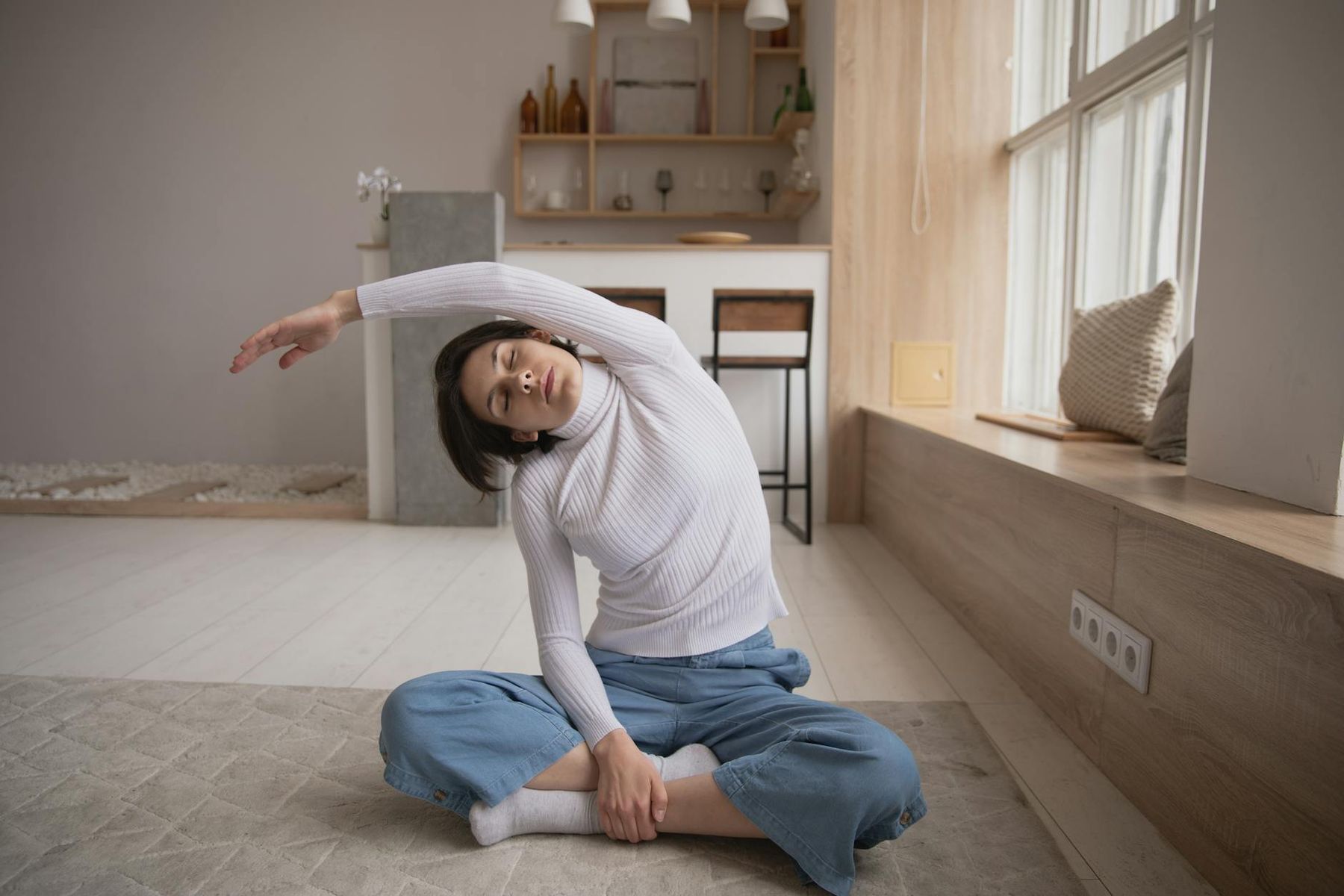 Woman performing a calm yoga pose with a soft filter.